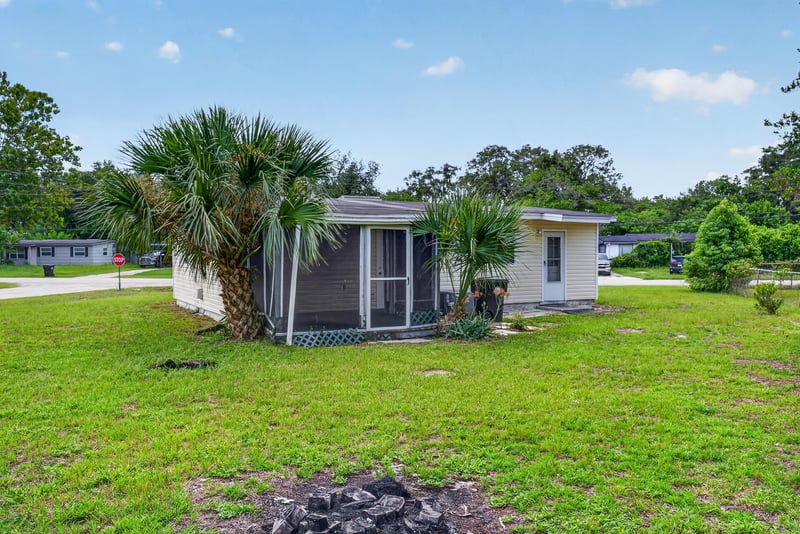 Side exterior with screened porch and street view at 255 Woodside Dr, Orange Park, FL 32073