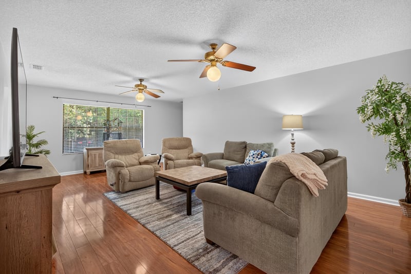 Living room with sofas and wood flooring at 2435 Range Line Rd, Middleburg, FL