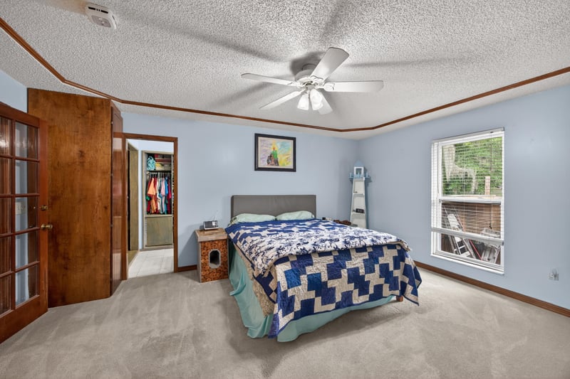 Primary bedroom with wood closet doors at 981 Marble Ridge Dr, Orange Park, FL 32065