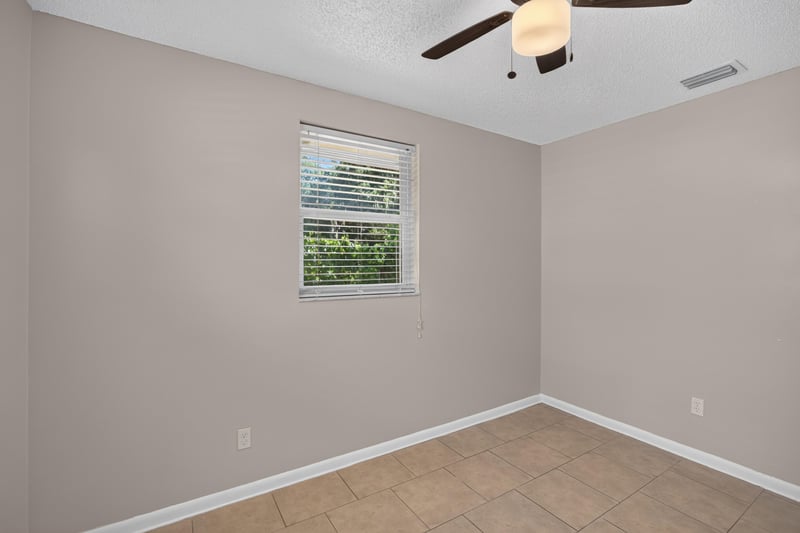 Bedroom with window and ceiling fan at 8067 Parental Cir, Jacksonville, FL 32216
