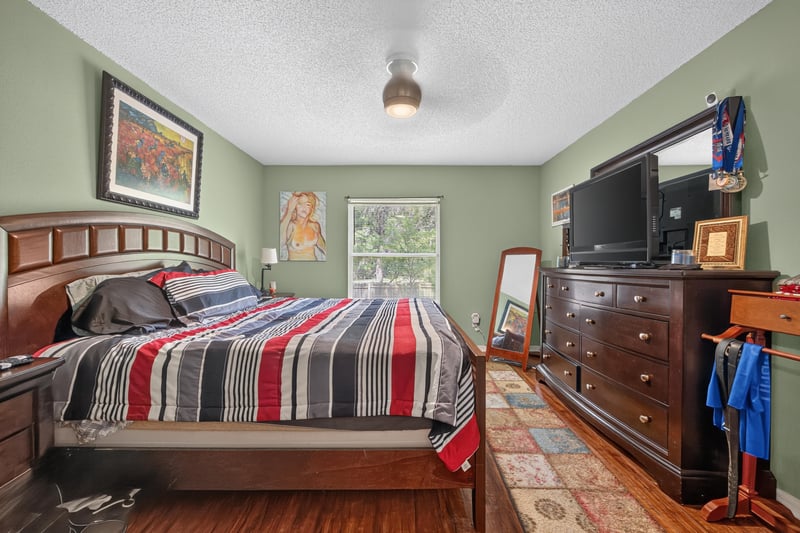 Bedroom with wood furniture and TV at 145 Dover Bluff Dr, Orange Park, FL