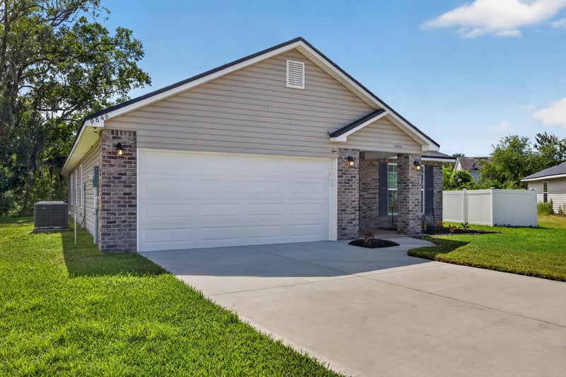 Front exterior side angle with landscaped yard at 9846 Olivia St, Jacksonville, FL