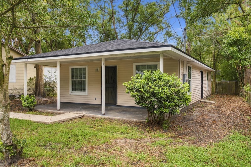 Front corner view with porch and landscaping at 219 Shortreed St, Jacksonville, FL 32254