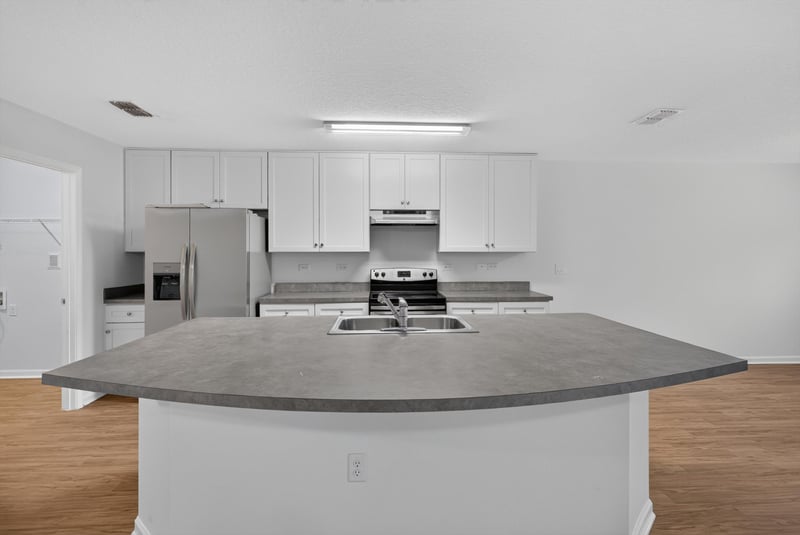 Kitchen island with range and cabinets at 95221 Siena Ct, Fernandina Beach, FL 32034