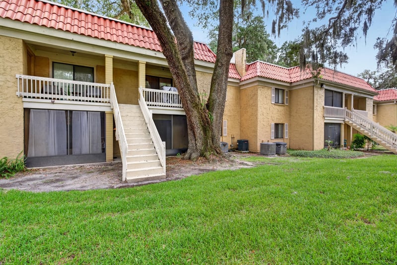 Condo building exterior with stairwell and courtyard at 5811 Atlantic Blvd unit 47, Jacksonville, FL 32207