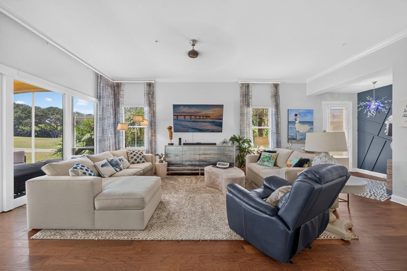 Living room with sofas and area rug at 140 Ave De La Mer, Palm Coast, FL 32137
