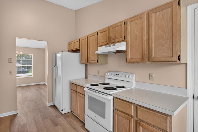 Kitchen with white range and overhead cabinets at 6646 Shiloh Creek Dr