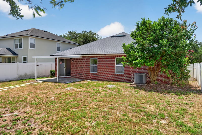 Backyard view with brick exterior at 224 Pine Arbor Cir, St. Augustine, FL 32084