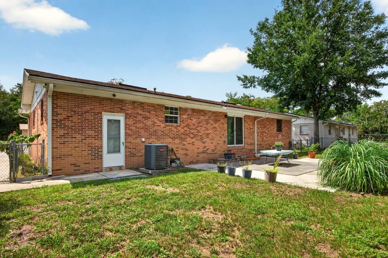 Backyard patio along brick exterior at 1847 Grove Park Dr, Orange Park, FL