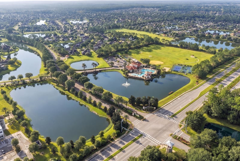 Aerial panorama of community entrance and lakes in Murabella