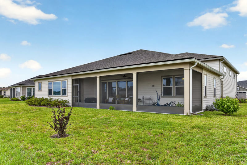 Rear exterior with screened porch and lawn at 85491 Fall River Pkwy, Fernandina Beach, FL 32034