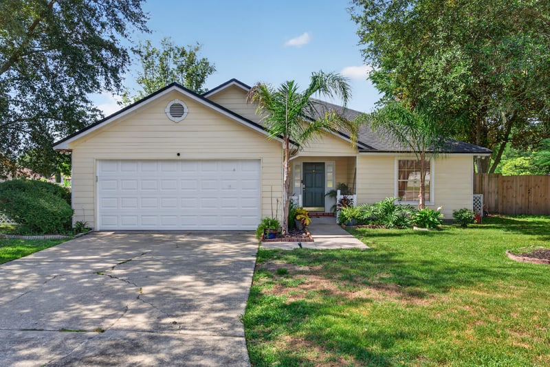 Front exterior with attached garage at 8680 Bandera Cir S, Jacksonville, FL 32244