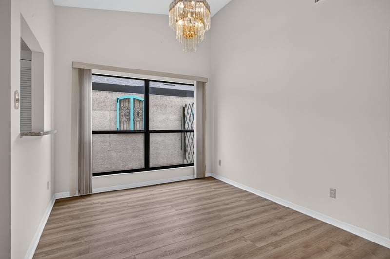 Empty room with screened window and chandelier at 3407 Fairbanks Grant Rd N, Jacksonville, FL 32223