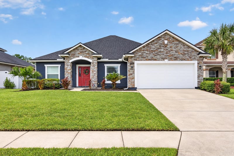 Front exterior with three-car garage at 538 Porta Rosa Circle, St. Augustine, FL 32092