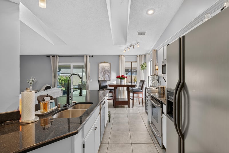Kitchen sink with window view and dining area beyond at 13020 Medford Ln, Jacksonville, FL 32225
