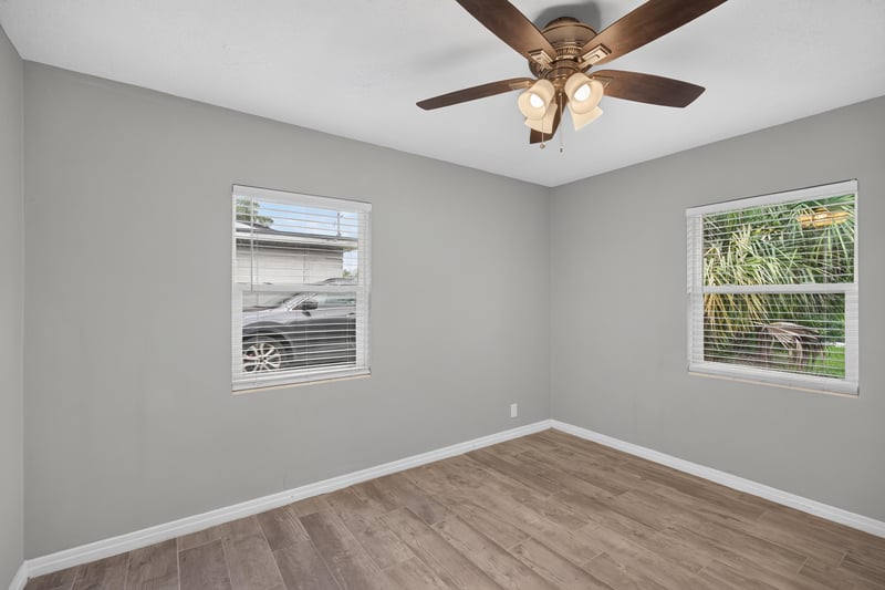 Bedroom, wood-look floors and two windows at 2256 Inwood Cir S, Jacksonville, FL