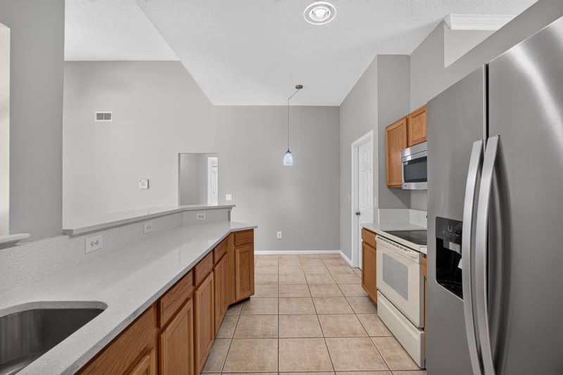 Kitchen with stainless appliances and tile floor at 9256 Dale View Ln W, Jacksonville, FL 32225
