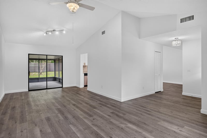 Open living area with vaulted ceiling and sliding doors at 551 Deltona Blvd, St. Augustine, FL 32086