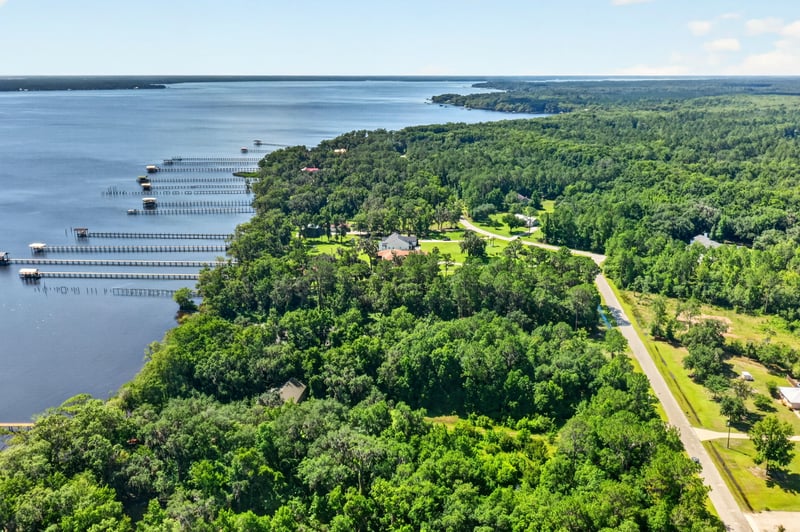 Aerial view of the river shoreline with a dock at 110 River Shores Rd, Palatka, FL 32043