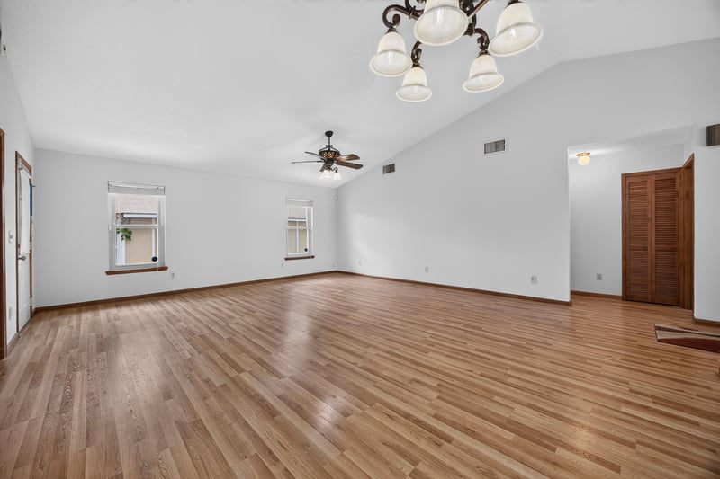 Empty living area showing vaulted ceiling and multiple doorways at 2460 San Sago Ln, Jacksonville, FL