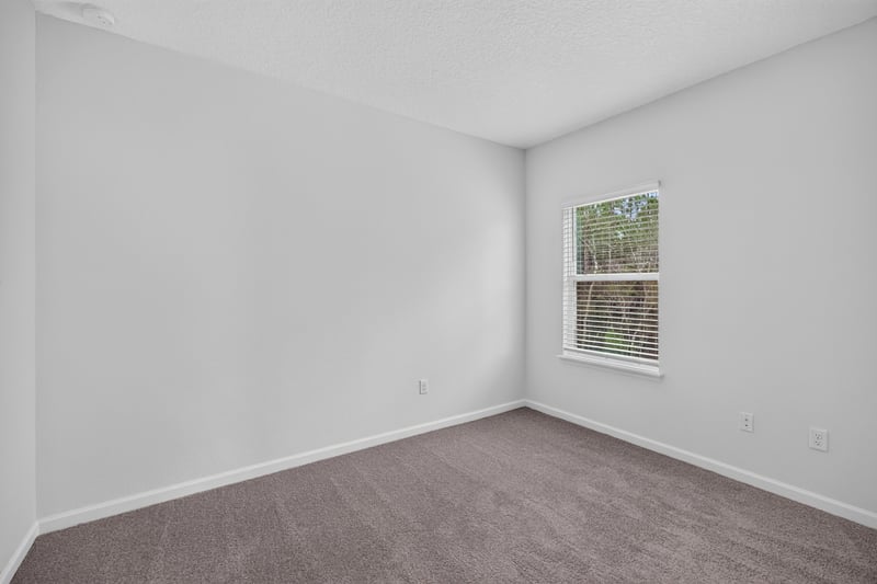 Bedroom with window and carpet flooring at 9905 Ansley Lake Dr, Jacksonville, FL