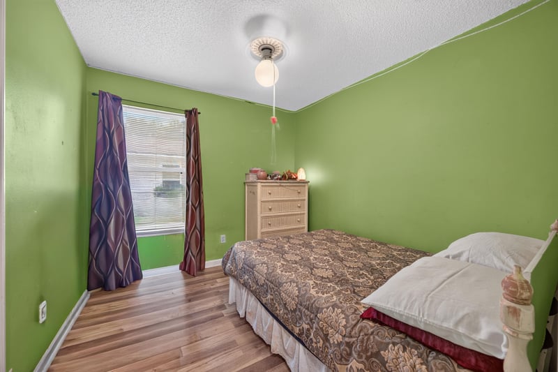 Bedroom with green walls and window at 5375 Dodge Rd, Jacksonville, FL 32209
