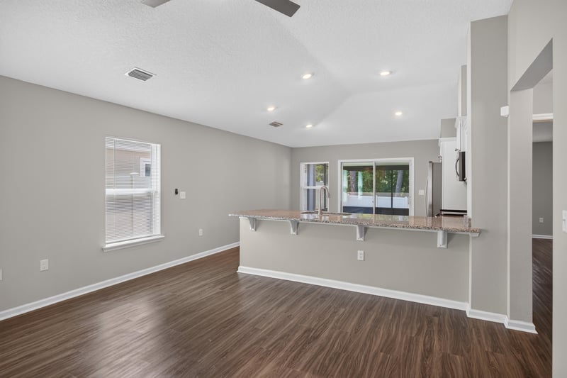 Living room open to kitchen bar counter at 7118 Preston Pnes Trl, Jacksonville, FL