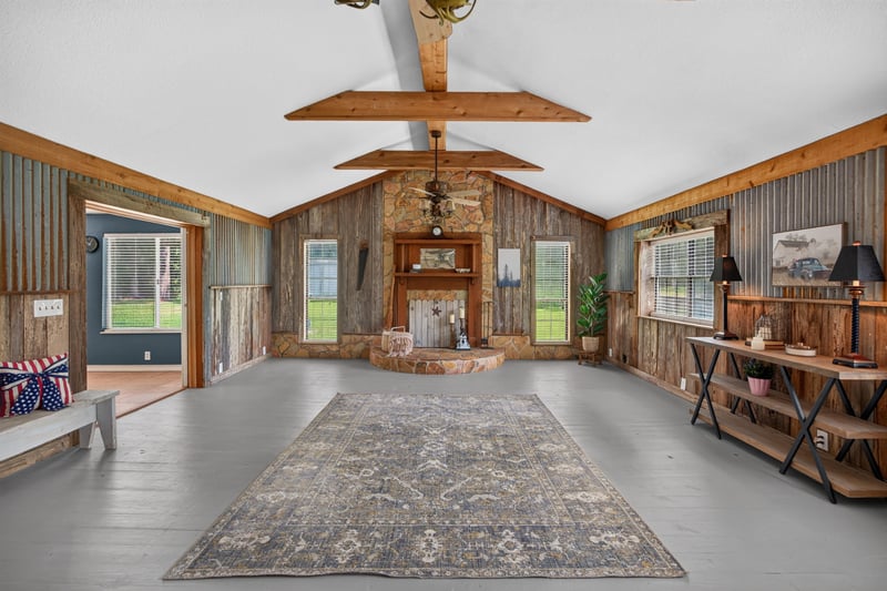 Great room with exposed beams and area rug at 5843 Ovella Rd, Jacksonville, FL 32244