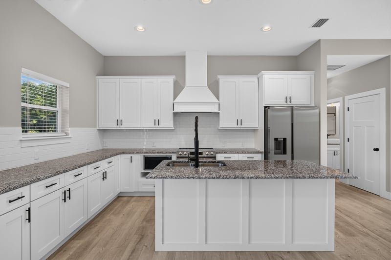 Kitchen with white cabinets and range hood at 175 Alava Ct
