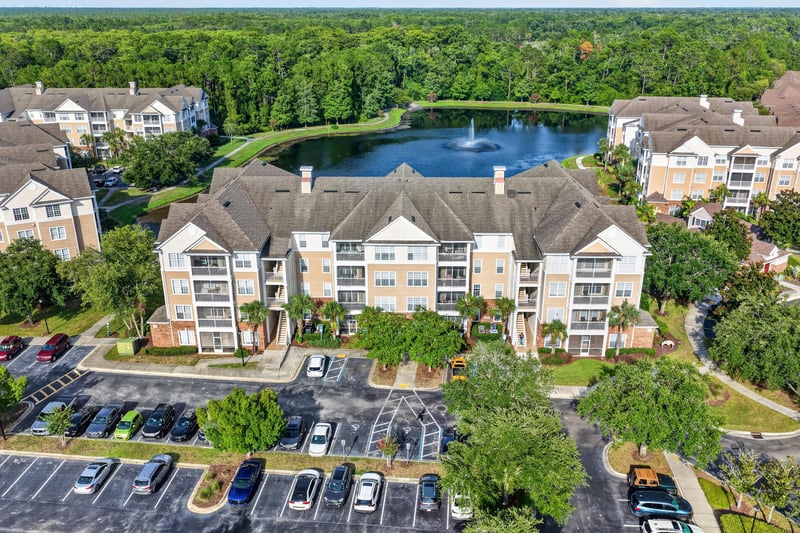 Aerial view of condo buildings around a lake in Jacksonville, FL