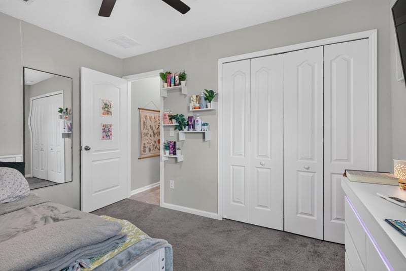 Bedroom with mirror and closet at 589 Seville Pkwy, St. Augustine, FL