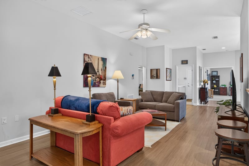 Living room with red sofa and coffee table at 11225 Water Spring Cir, Jacksonville, FL 32256