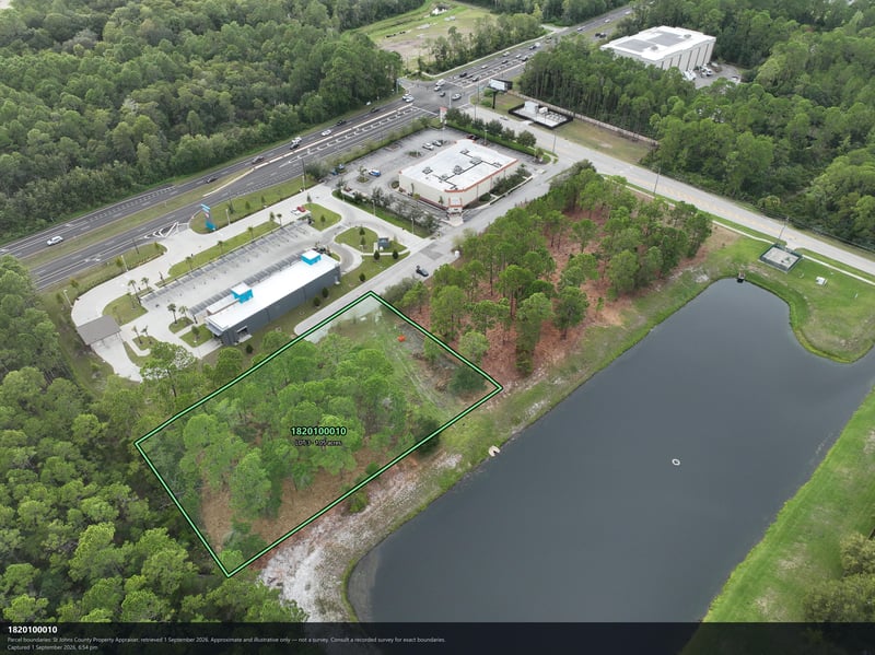 Aerial view of the pond and wooded parcel boundary at 4900 US-1, St. Augustine, FL 32086