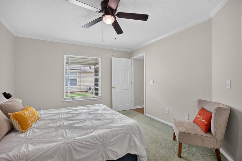 Primary bedroom with window and closet doors at 605 N Covered Bridge Rd, Jacksonville, FL