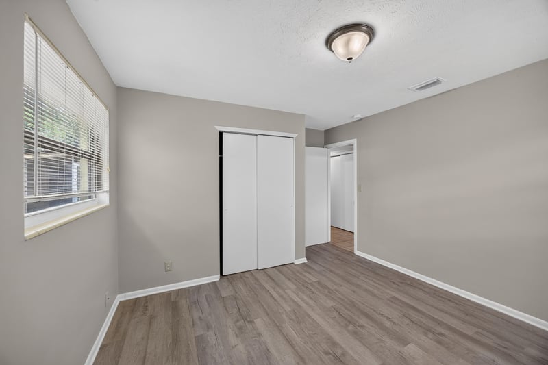 Bedroom with wood-look flooring and closet at 5527 Beney Rd, Jacksonville, FL 32207