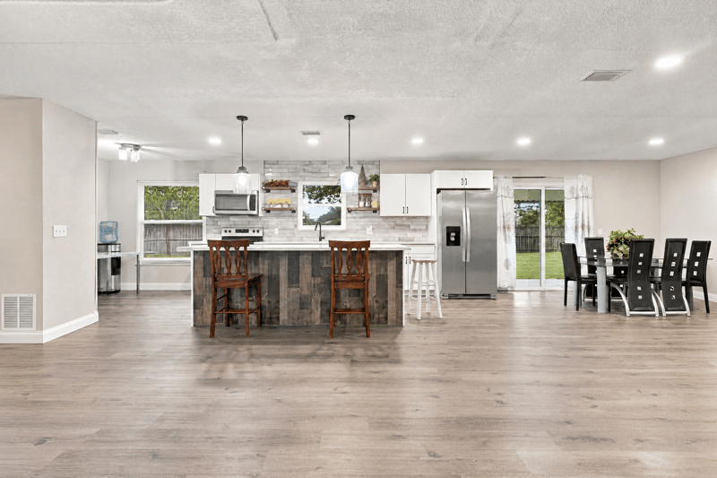 Open kitchen with island and stainless refrigerator at 357 Dillon Dr, Orange Park, FL