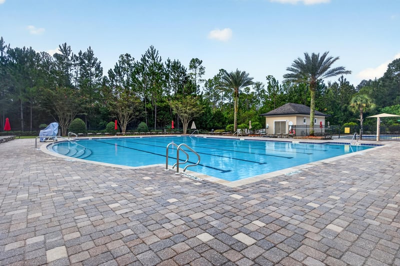 Community pool with lounge chairs in River Glen