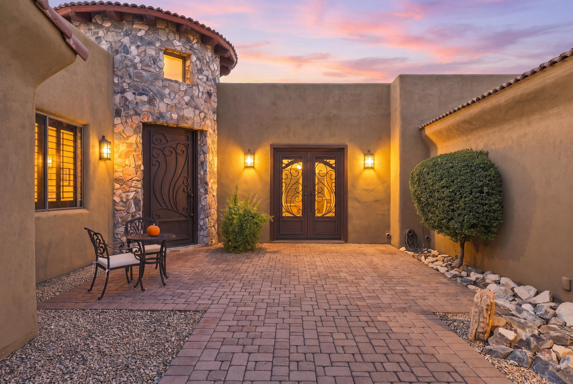 Virtual twilight of a stone tower entry with carved wood doors