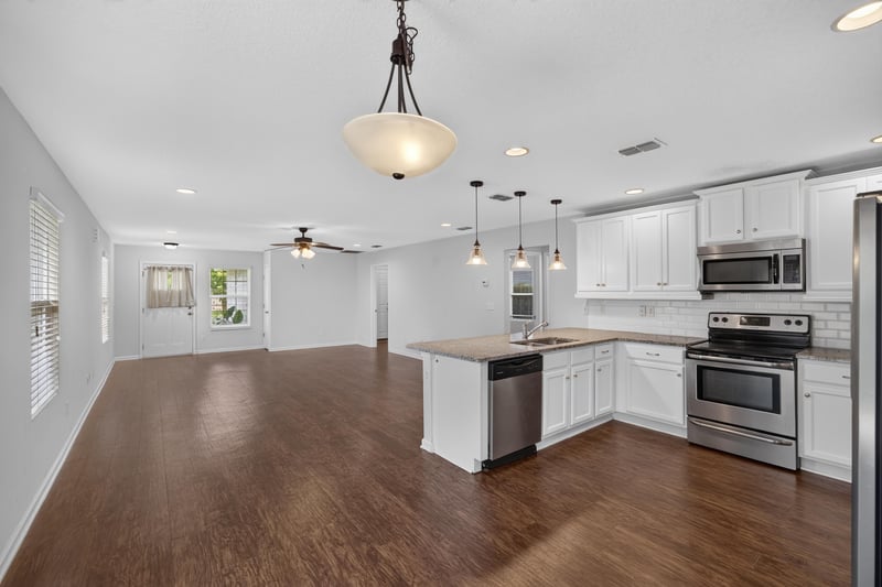 Kitchen view with pendant lighting and stainless fridge at 1002 Ingleside Ave, Jacksonville, FL 32205