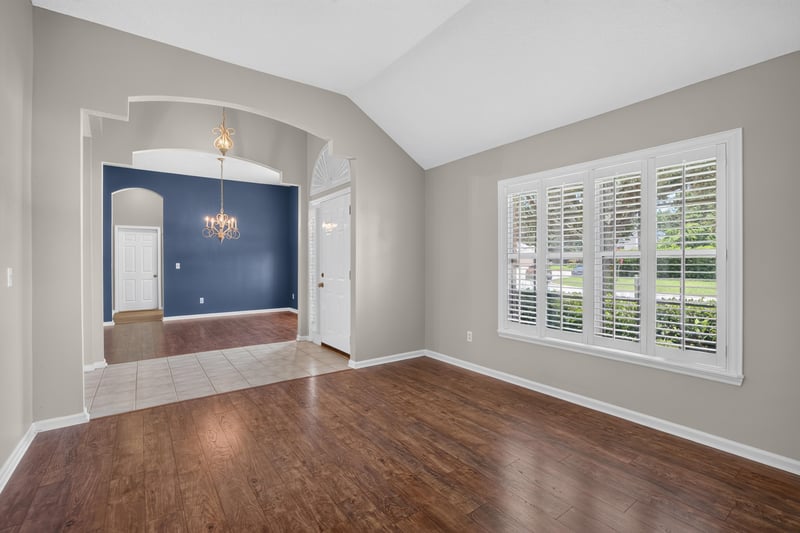 Dining room with blue walls and arched window at 1955 GUARDED Way, Fleming Island, FL 32003