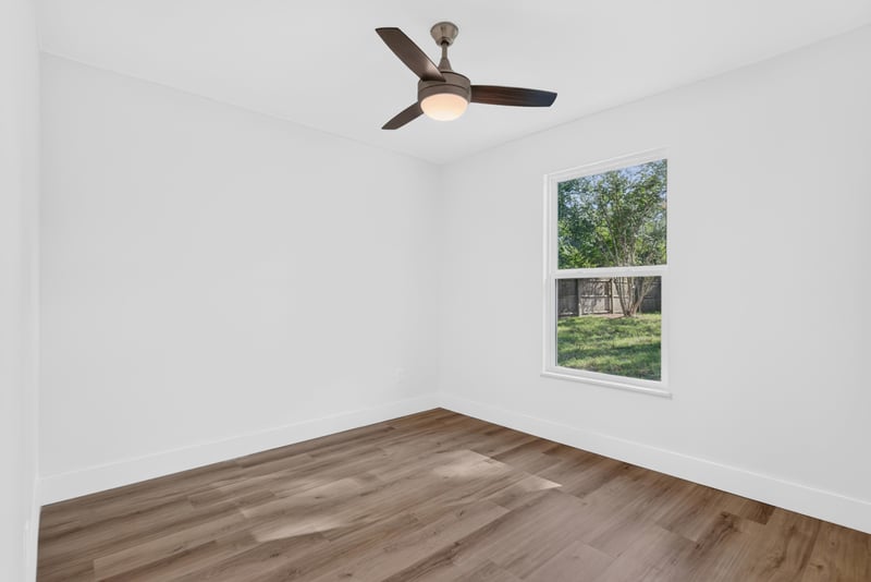 Empty bedroom with window and ceiling fan at 8453 Boysenberry Ln W, Jacksonville, FL