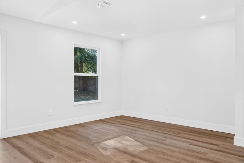 Empty room with single window and wood flooring at 8453 Boysenberry Ln W, Jacksonville, FL