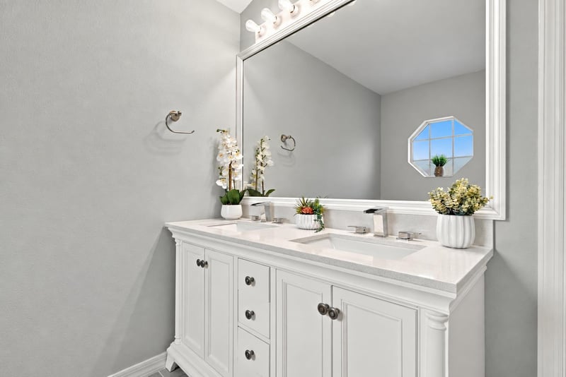 Primary bathroom vanity with octagon window at 11197 Illford Dr