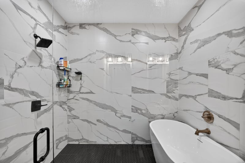 Primary bathroom with marble tile shower and freestanding tub at 2817 Camel Cir, Middleburg, FL