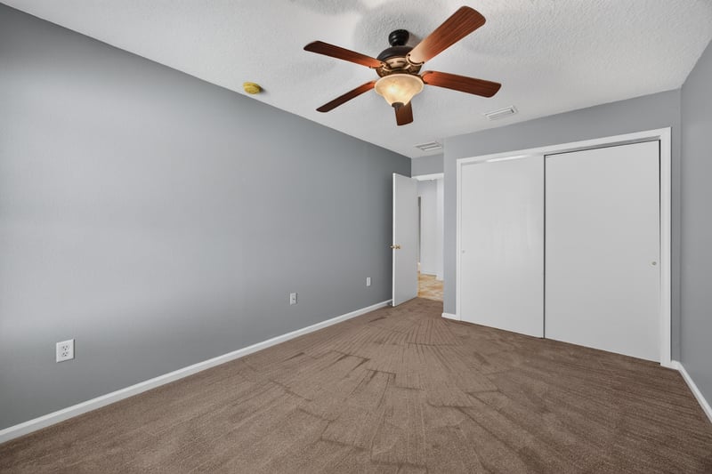 Empty bedroom with closet doors at 2282 Justin Lake Dr, Jacksonville, FL