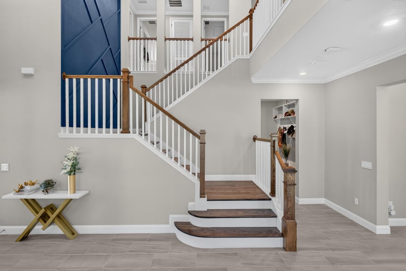 Staircase view with navy accent wall at 22 Azura Point