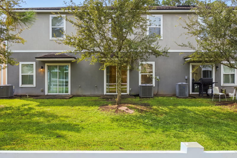 Backyard view with AC unit and patio at 9555 Star Dr, Jacksonville, FL 32256