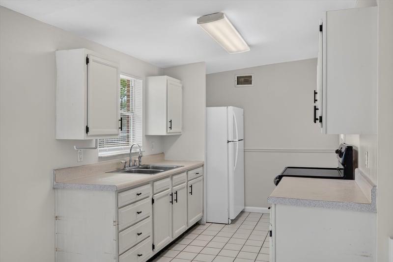 Kitchen with cabinets and window at 87 Saratoga Cir S, Atlantic Beach, FL
