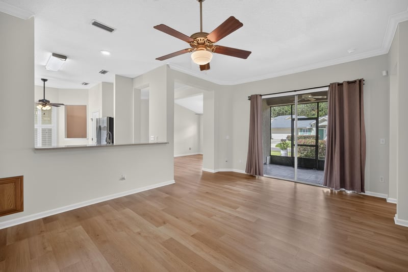 Living room with sliding glass doors to backyard at 2131 E Stone Creek Dr, Fleming Island, FL