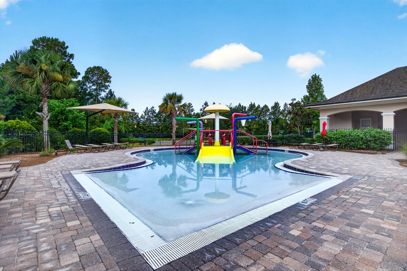 Community pool with shaded seating in River Glen